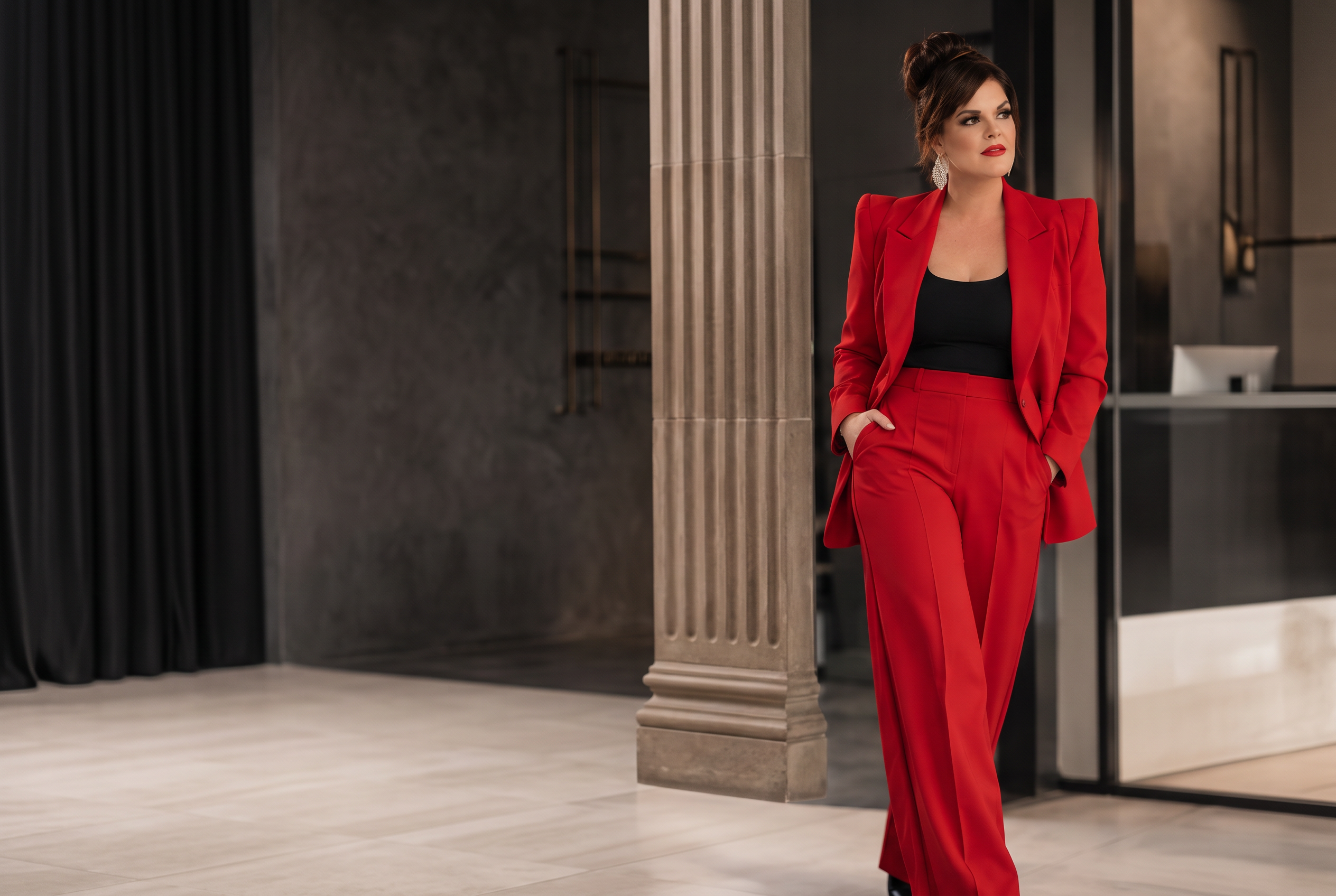 Yolandi Kahl walking through a refined business interior in a red suit